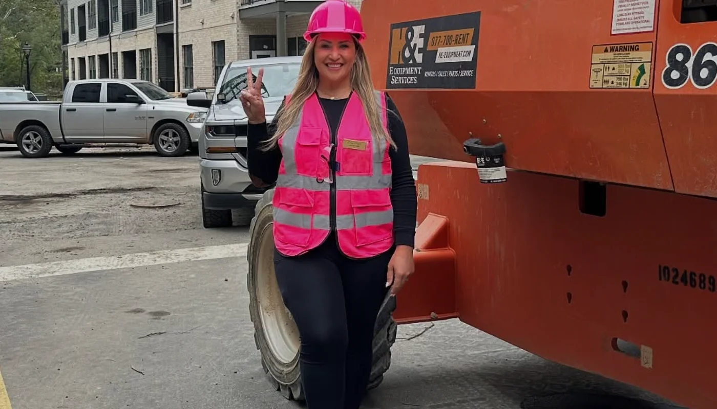 Amy wearing a hard hat and safety vest at a construction site